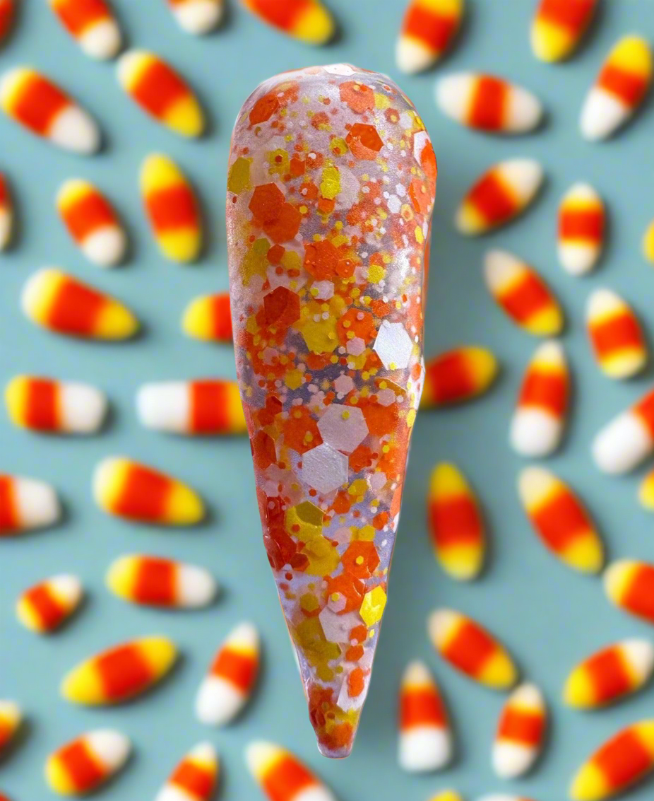 Halloween-themed acrylic nail design with orange, yellow, and glitter accents using Haunted Hayride acrylic powder.