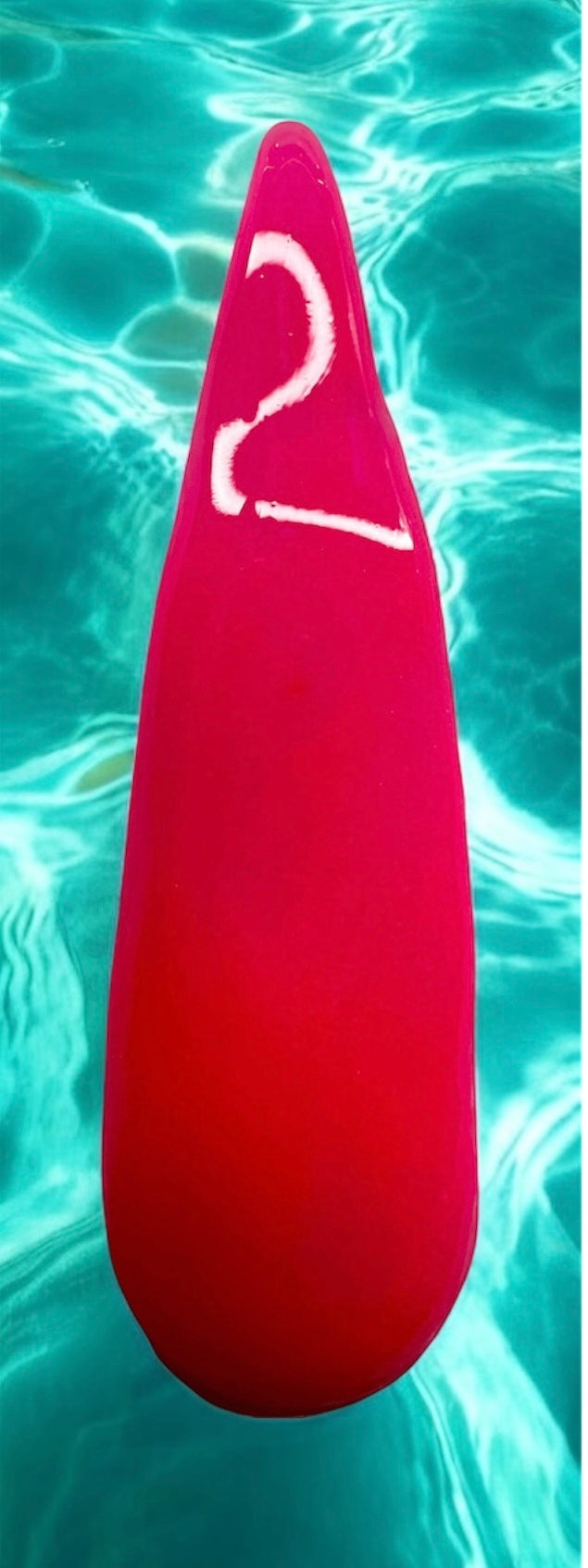 Neon Nail acrylic in vibrant pink from Pool Party Collection, set against a watery background.