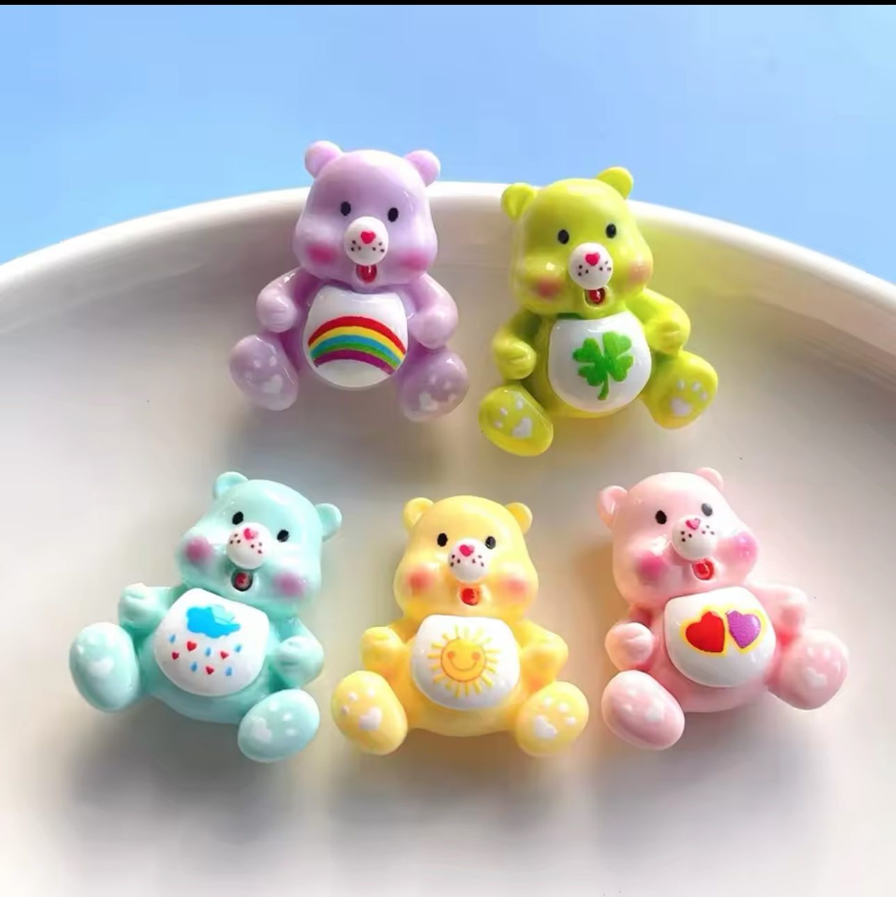 Care Bear Nail Charms set with colorful designs on a plate.