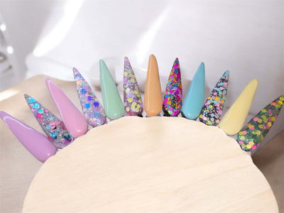 Pastel glitter acrylic powders in various colors for Easter-themed nail designs.