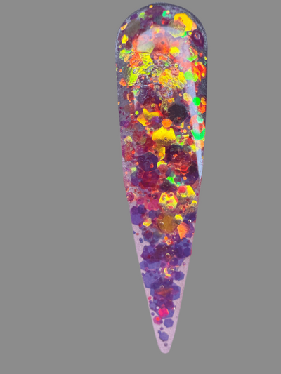 Halloween themed glitter acrylic nail powder with orange, yellow, and purple sparkles on a stiletto nail tip