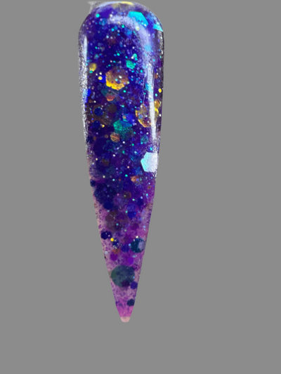 Halloween themed nail glitter acrylic powder with purple and blue sparkles on a nail tip