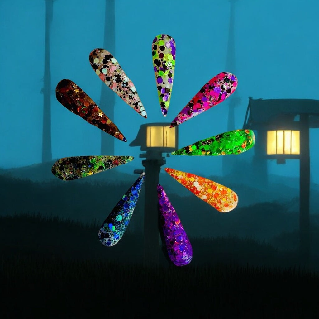 Set of long stiletto acrylic nails in glittery Halloween colors from the Haunted Hayride collection displayed against a spooky night background with lanterns.